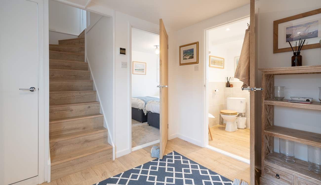 From the entrance area, stairs lead down to the lower floor bedrooms and bathrooms. Please note the staircase is steep. 