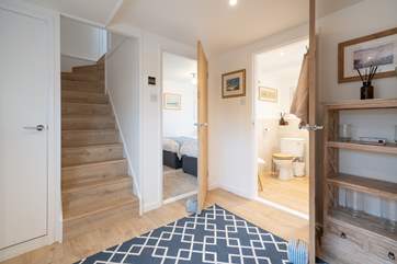 From the entrance area, stairs lead down to the lower floor bedrooms and bathrooms. Please note the staircase is steep.
