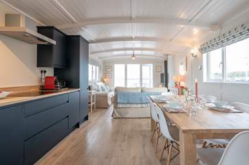 The open plan living, dining and kitchen space is perfect for social dinners and cosy evenings.