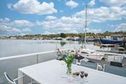 Watch the tide ebb and flow from the deck and admire the surrounding houseboat community.