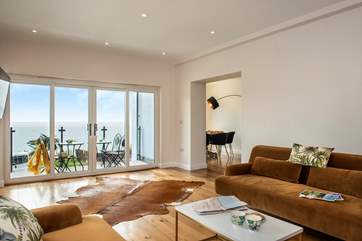 Large bi-fold doors lead out to the balcony.