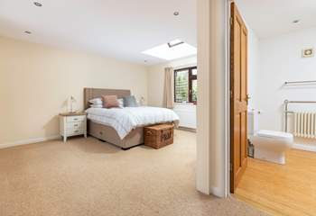 The main bedroom offers oodles of space to spread out, which links into the en suite with roll-top bath.