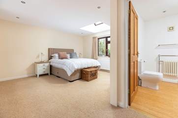 The main bedroom offers oodles of space to spread out, which links into the en suite with roll-top bath.