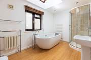 The glorious en suite bathroom features this fabulous roll-top bath.