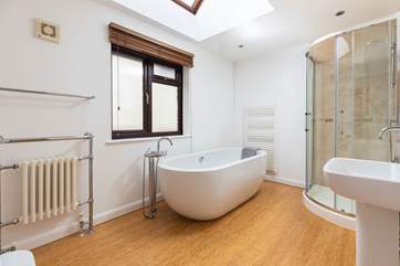 The glorious en suite bathroom features this fabulous roll-top bath.
