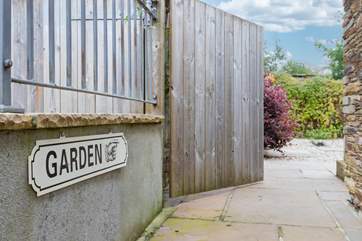 The garden is accessed at the side of the house.