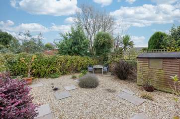 The fully enclosed garden offers a lovely space to enjoy a touch of dining al fresco or a good book.