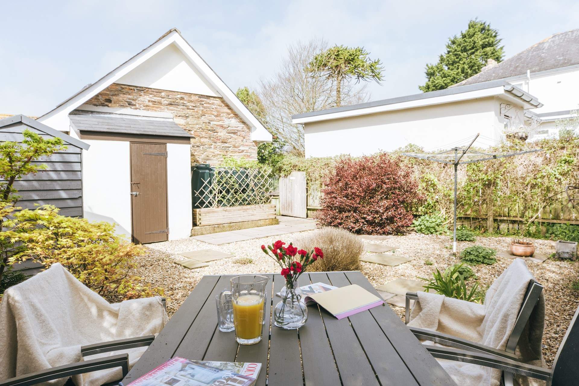 The fully enclosed garden offers a lovely space to enjoy a touch of dining al fresco or a good book.