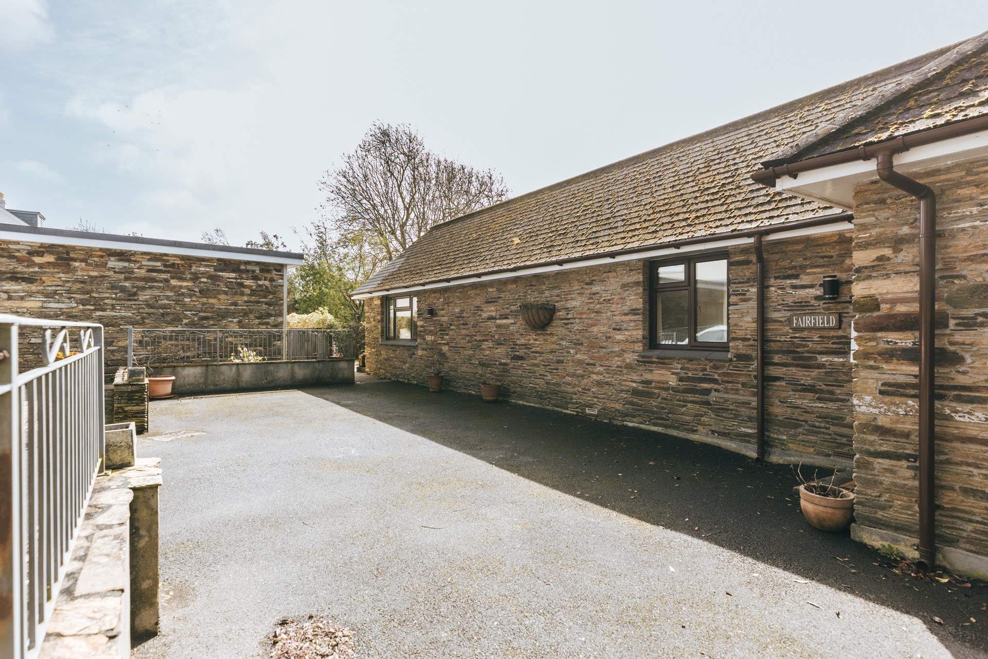 The enclosed garden is accessed across the private parking area.