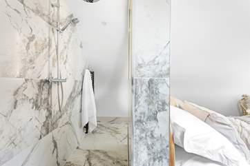 The shower behind the bed.
