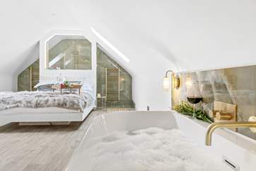 All the bedrooms here are rather special. This is bedroom two with a roll top bath and king-size bed.