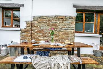 Make the most of the weather with al fresco dining at the front of the cottage.