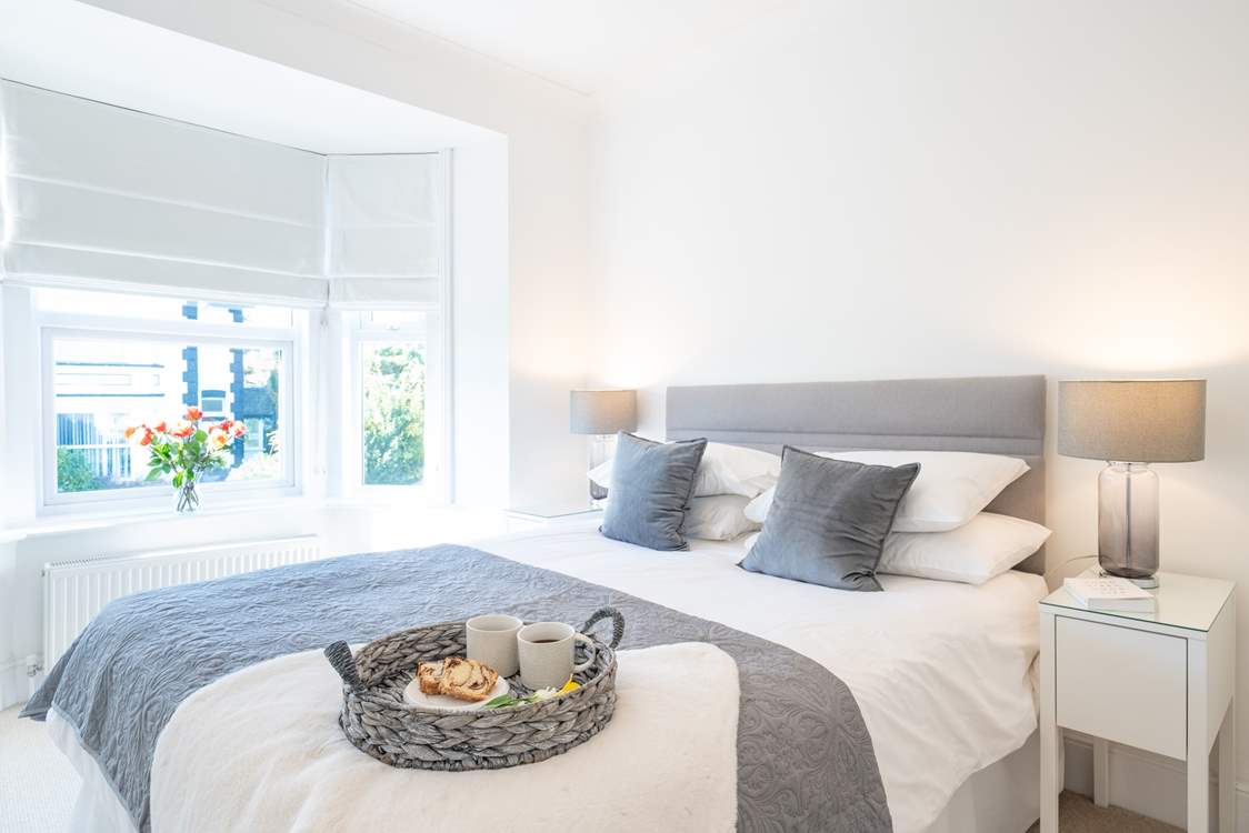 The main bedroom on the first floor is beautifully decorated in muted shades.