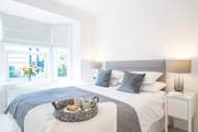 The main bedroom on the first floor is beautifully decorated in muted shades.