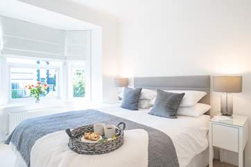 The main bedroom on the first floor is beautifully decorated in muted shades.