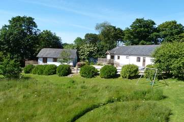 Orchard Cottage is the property on the right, enjoy playing in the meadow or swing set which is shared with Bramley Cottage.