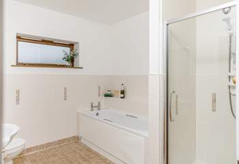 The family bathroom has a large bath tub and separate shower. 