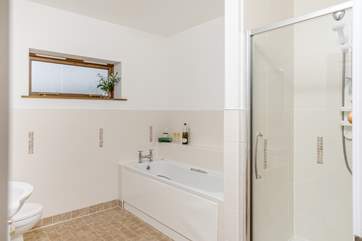 The family bathroom has a large bath tub and separate shower.