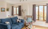 The cosy sitting area looks out onto the decking and fields.  - Thumbnail Image