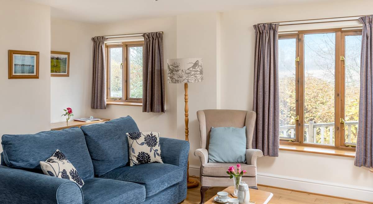 The cosy sitting area looks out onto the decking and fields. 