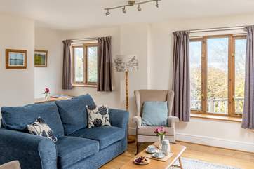 The cosy sitting area looks out onto the decking and fields.