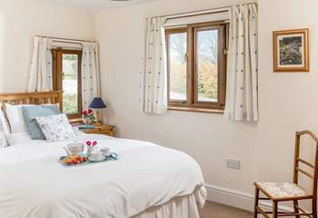 The main bedroom enjoys views over the fields, with only the sound of bird song to hear. 