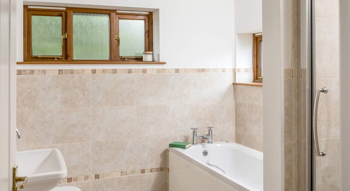 The family bathroom has a large bath for two and a separate shower. 