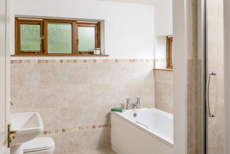The family bathroom has a large bath for two and a separate shower. 