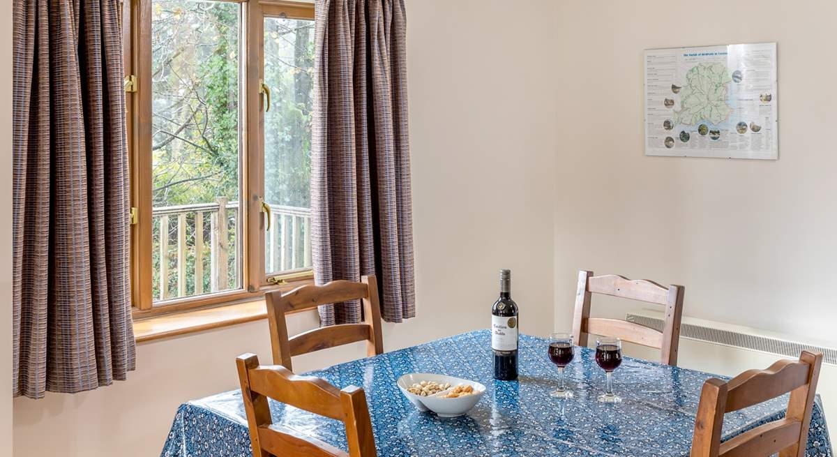 The dining-table looks out over the decking and trees beyond where you might spot a wren or robin perhaps. 