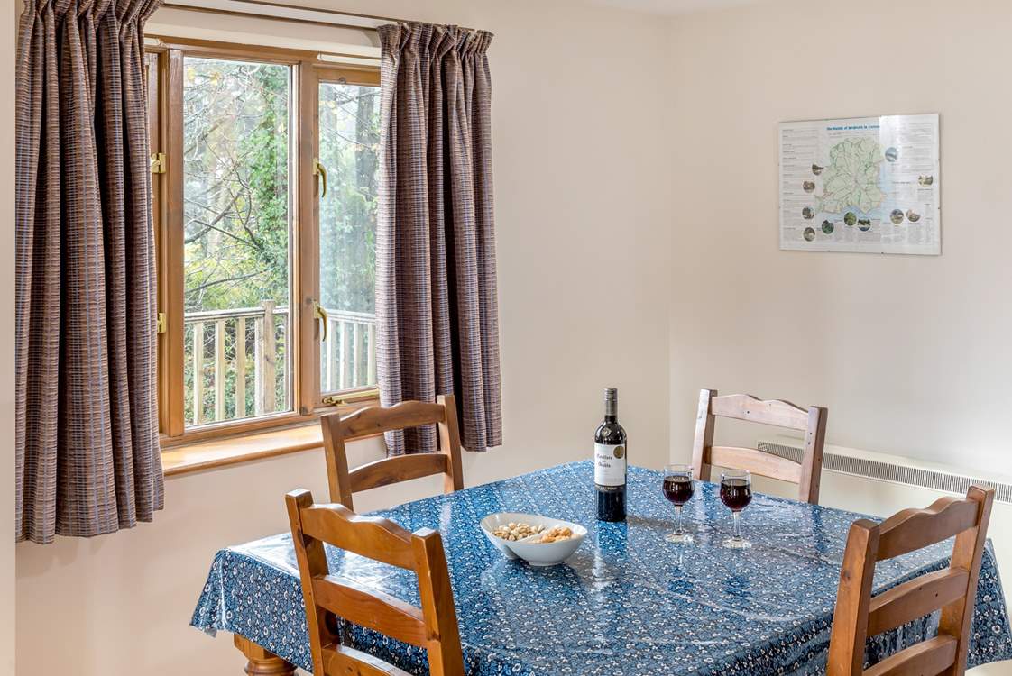 The dining-table looks out over the decking and trees beyond where you might spot a wren or robin perhaps.