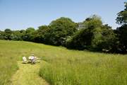 Enjoy all the space on offer winding through the paths in the meadow which is shared with Orchard Cottage.