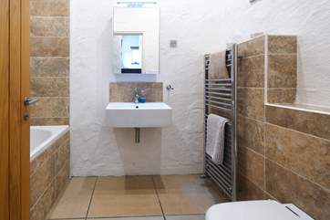 Stylish family bathroom on the entrance level.