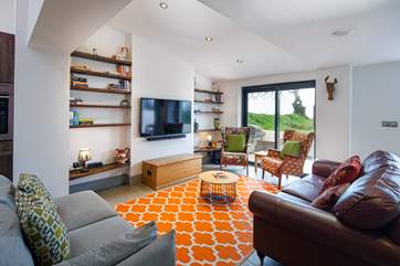 The comfortable living-room leads out to the patio .