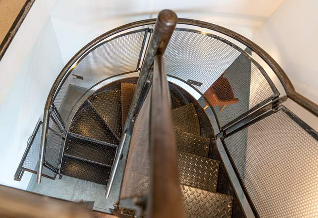 Climb the amazing  bespoke metal staircase leading up to the spectacular views from the  reading-room leading into the superb master bedroom.