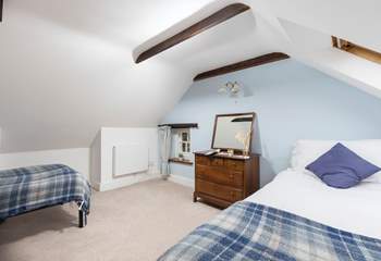 Upstairs is the second twin bedroom which has exposed beams and sloping ceilings.