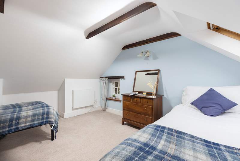 Upstairs is the second twin bedroom which has exposed beams and sloping ceilings.