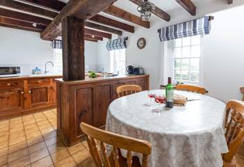 The handmade kitchen, made of reclaimed wood, fits seamlessly with the original oak beams.