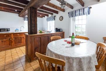 The solid oak kitchen fits seamlessly with the original oak beams.