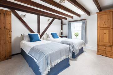 Sweet dreams are guaranteed in this lovely twin bedroom.