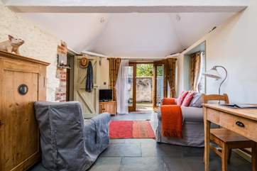 This characterful single-storey dwelling has original exposed brickwork and traditional slate floors.