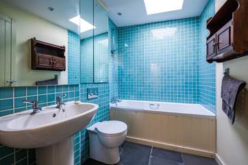 The bathroom has a bath with shower over, perfect for a refreshing shower or a long soak after a day of adventure.
