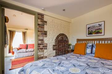 The delightful bedroom with lovely stonework.