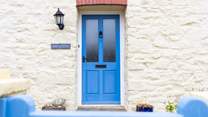 The blue front door welcomes you to Swn Y Mor. 