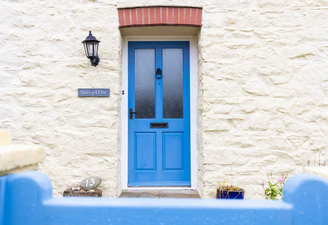 The blue front door welcomes you to Swn Y Mor. 