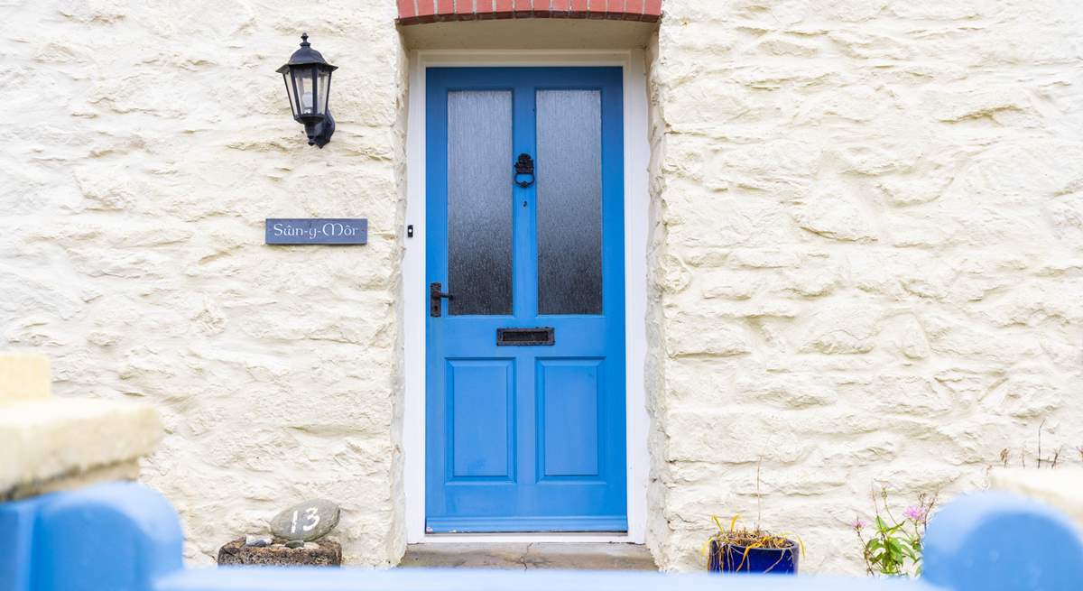 The blue front door welcomes you to Swn Y Mor. 