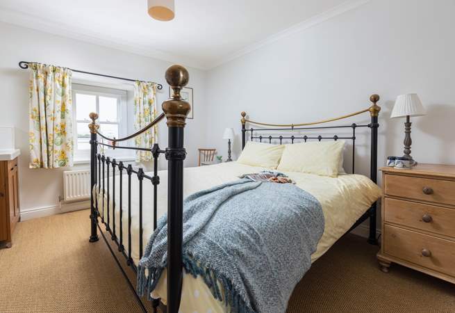 The main bedroom has a fabulous super-king size bed and a lovely brass bedstead. 