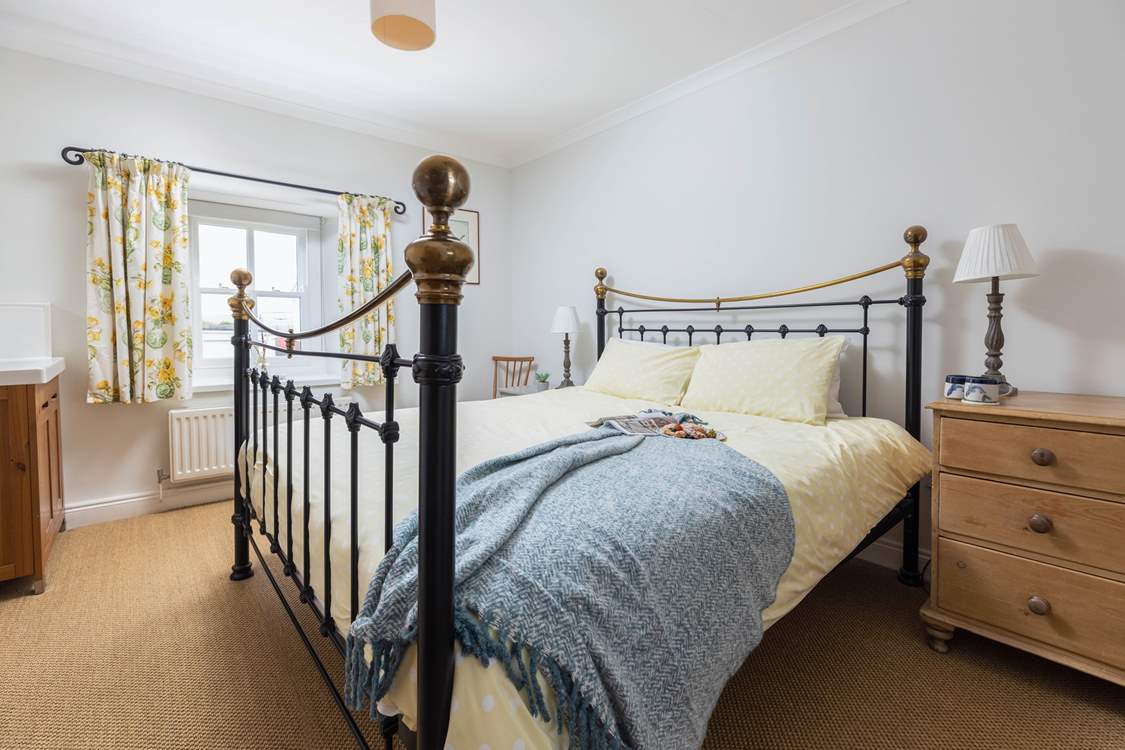 The main bedroom has a fabulous super-king size bed and a lovely brass bedstead.