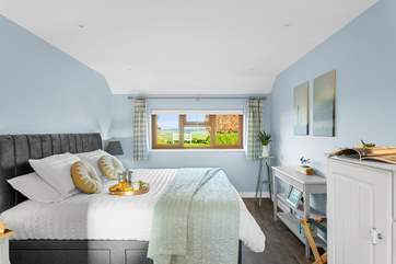 The gorgeous bedroom has fabulous countryside views.