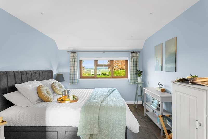 The gorgeous bedroom has fabulous countryside views.
