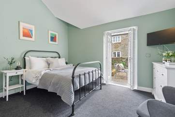 Bedroom Three is a beautiful room with doors leading out to the terrace.